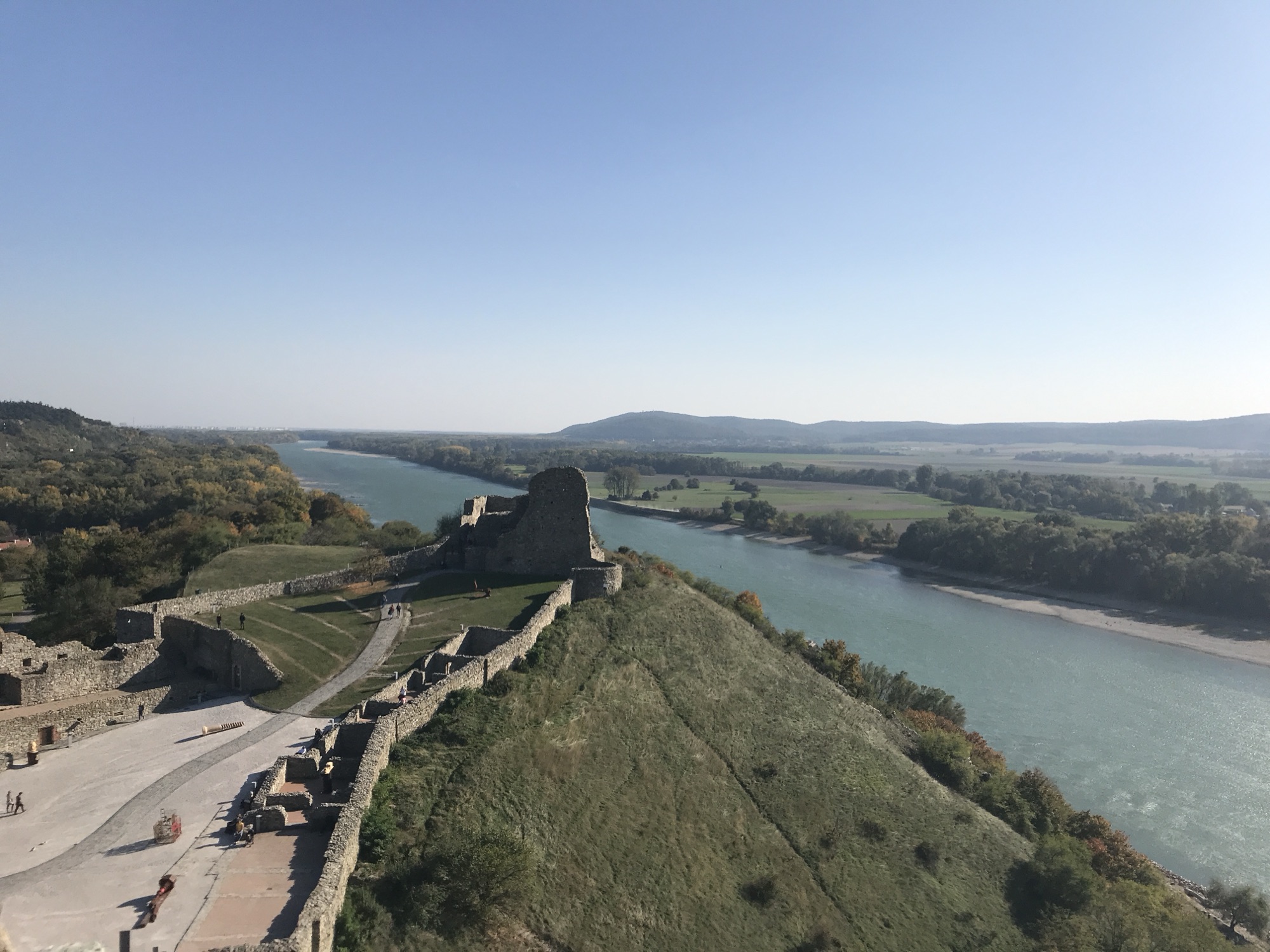 Devín Castle walls on the cliff above the turquoise Danube near Bratislava